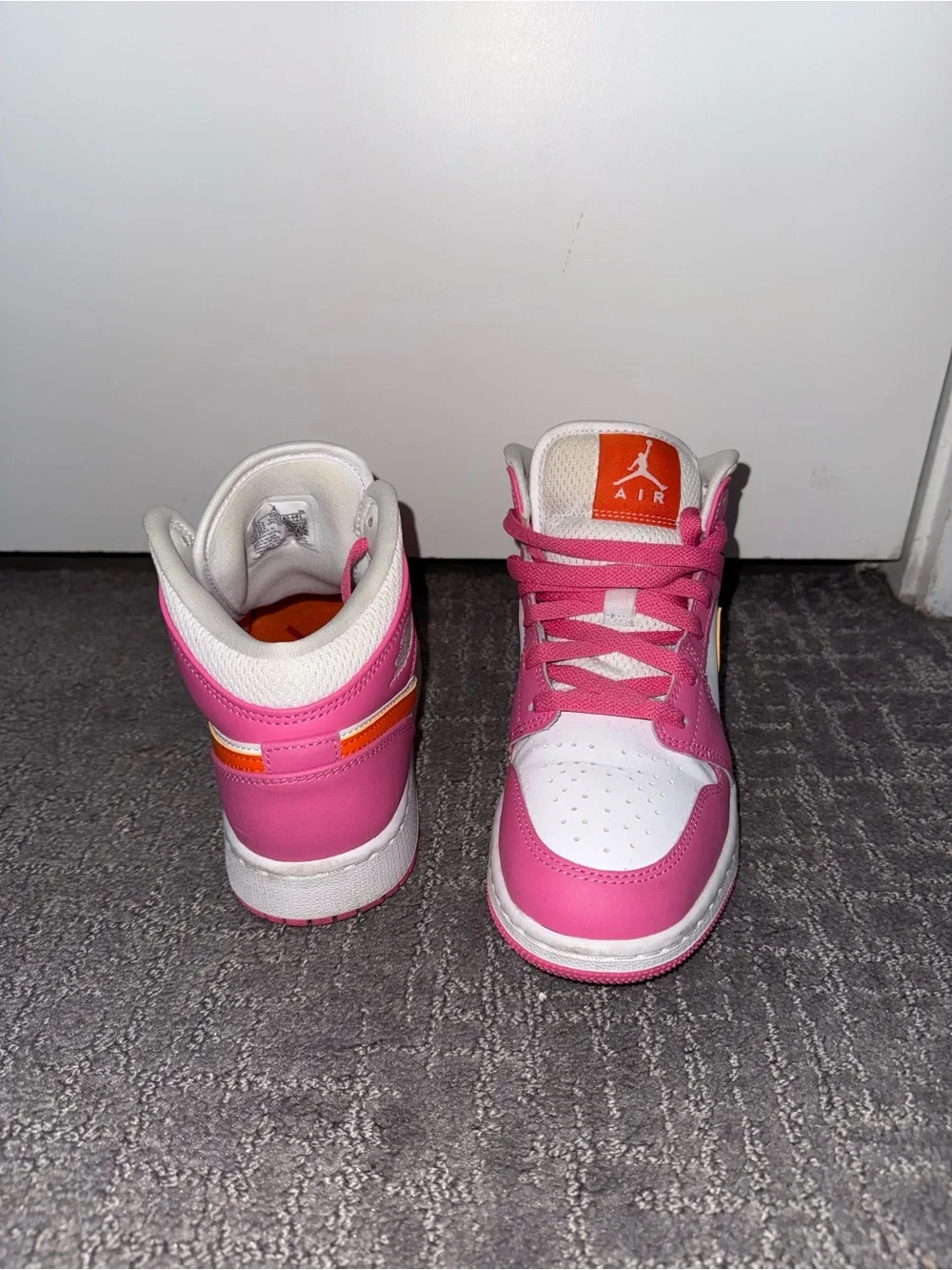Jordan Pink and White High-Top Sneakers with Orange Tongue Logo